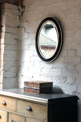 A Decorative c.1880 Ebonised Oval Wall Mirror