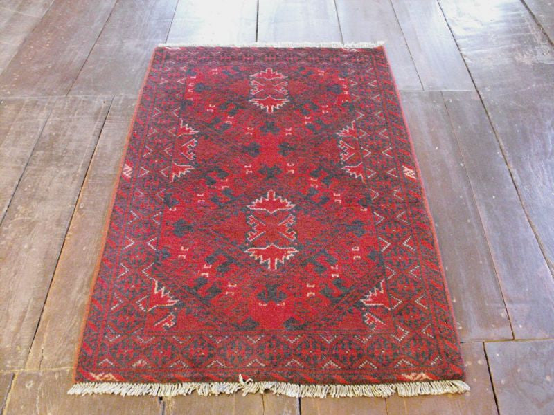 A Durable Red Afghan Rug: 119cm x 77cm