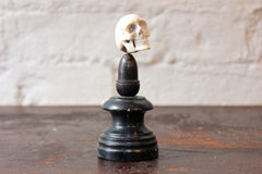A Curious Early 20thC Miniature Carved Bone Model of a Human Skull Upon an Ebonised Column