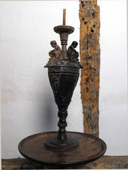 A Classical Form Spelter Lamp with Putti & Grapes above Bacchus Heads