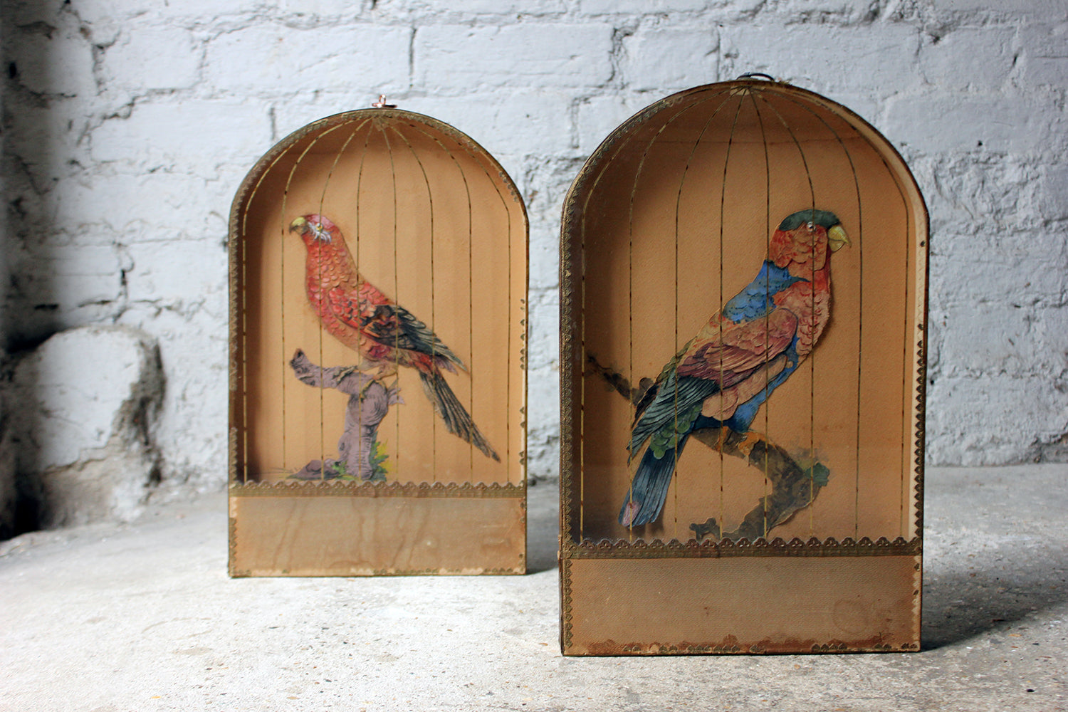 A Charming & Unusual Pair of Early 19thC Continental Appliqué Paper Pictures In The Form of Caged African Parrots c.1800-25