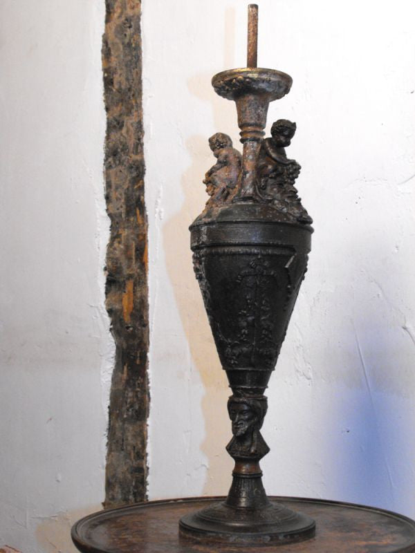 A Classical Form Spelter Lamp with Putti & Grapes above Bacchus Heads
