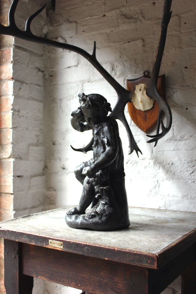 A Beautiful George III Period Lead Garden Ornament Cast as a Bacchanalian Putto